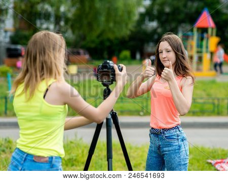 Two Girl Friends. Summer In Nature. Writes The Video To Camera. Gestures With Hands Showing Thumbs U