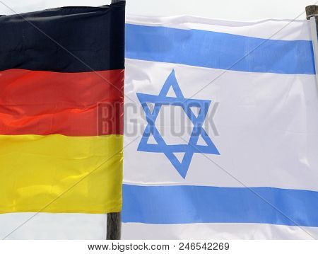 Flags Of Germany And Israel Waving In The Wind