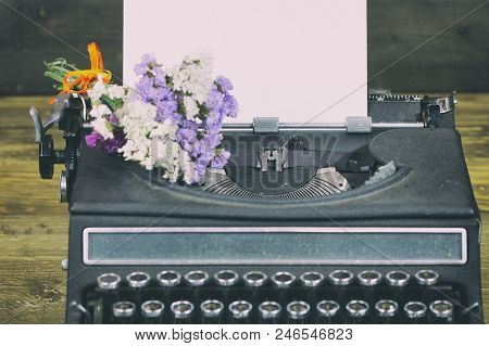 Old Typewriter With Paper And Dried Flowers