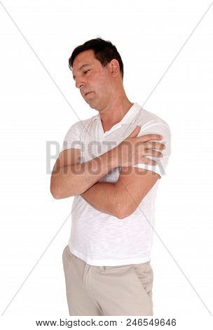 A Tall Handsome Middle Age Man Standing In A Beige Slacks And White
T-shirt With His Arms Crossed, I