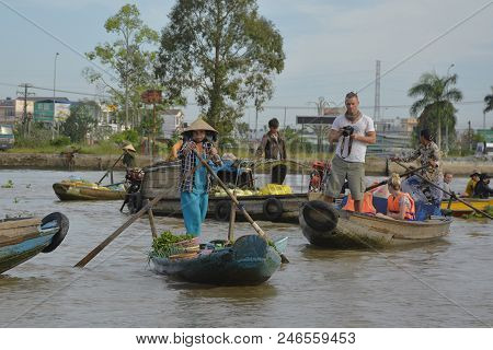 Phong Dien, Vietnam - December 31st 2017. A Tourist On A Boat Tour Takes Photos Of A Vendor At The P