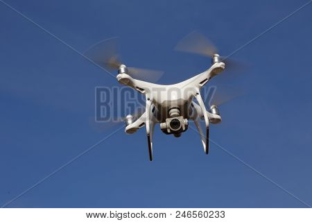 Tullgarn, Sweden - May 6, 2018: One Dji Phantom 4 Quadcopter In Flight Against A Blue Sky.