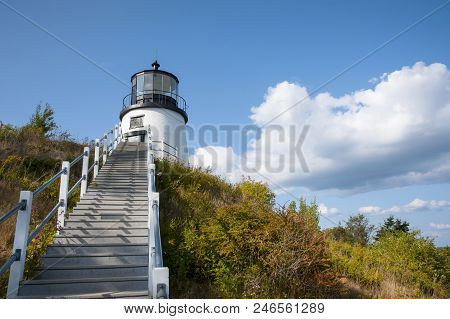 Stairs Lead Up To Olws Head Lighthouse Situated Above A Cliff On A Summer Day In Maine. It Is A Popu