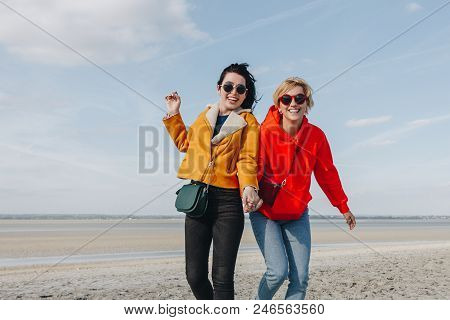 Smiling Female Friends On Sandy Beach, Saint Michaels Mount, Normandy, France