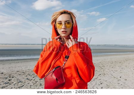 Beautiful Girl In Red Hoodie Standing On Beach, Saint Michaels Mount, France