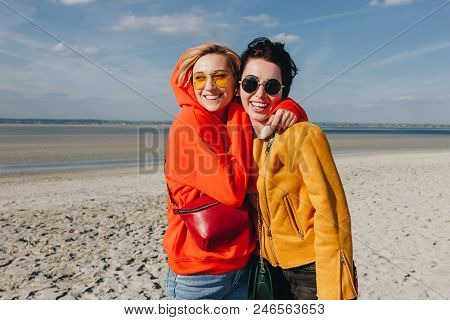 Happy Female Friends Hugging On Sandy Beach, Saint Michaels Mount, Normandy, France