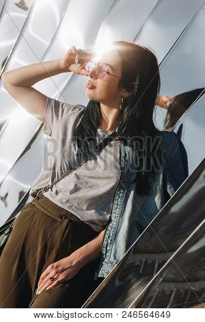 Wroclaw, Poland - 18 May 2018: Stylish Young Woman In Front Of Sculpture Made Of Reflective Material