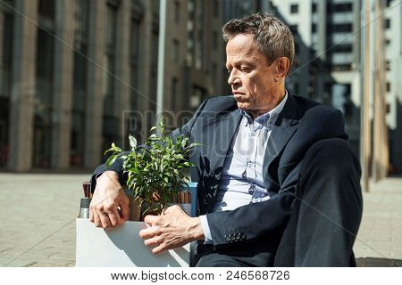 Grief Stricken. Grief Stricken Elderly Wrinkled Business Man Feeling Very Bad After Being Fired From