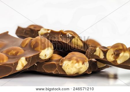 Milk Chocolate Pieces With Whole Hazelnuts. Chocolate Bar / Chocolate Background/ Nut Chocolate / Ch