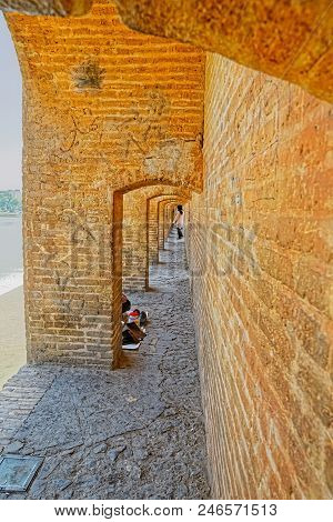 Isfahan, Iran - May 8, 2015: People Resting And Enjoying The View Of The Zayandeh River From The Anc