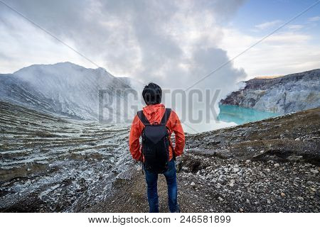 Young Travler Looking At Sulfur Burned By Blue Flame In The Crater Blue Lake At Kawah Ijen, Indonesi