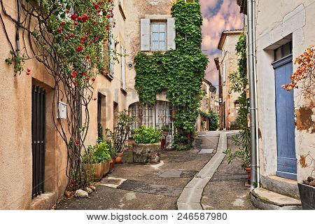 Lourmarin, Vaucluse, Provence, France: Picturesque Ancient Alley In The Old Town With Plants And Flo