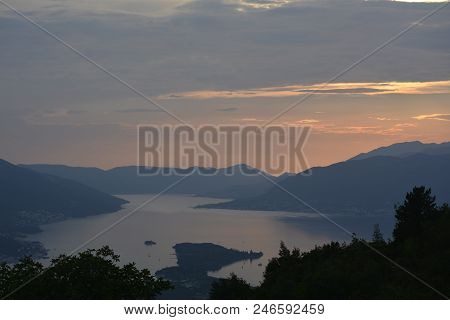 Sunset In The Bay And A View Of The Mountains In Pink Tones.