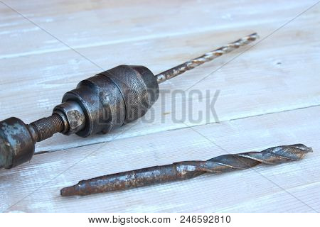 Old Hand Drill Against The Background Of Boards