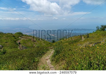 Hillside With Flowers Leading Down To The View Of Lake Nicaragua And The Granada Islands In The Rain