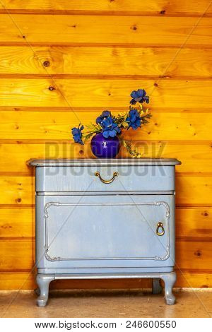 Ancient Blue Drawers Placed In Front Of Wooden Wall.