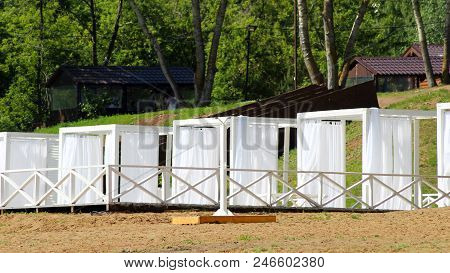 Beautiful Small Bathing Houses On Yellow Sandy Beach