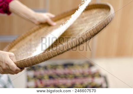 Housewife Winnowing Rice By Using Bamboo Basketwork For Separate Between Rice And Rice Husk.selectiv