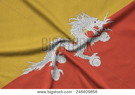 Bhutan Flag  Is Depicted On A Sports Cloth Fabric With Many Folds. Sport Team Waving Banner