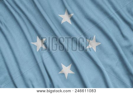 Micronesia Flag  Is Depicted On A Sports Cloth Fabric With Many Folds. Sport Team Waving Banner