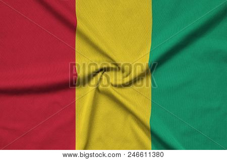 Guinea Flag  Is Depicted On A Sports Cloth Fabric With Many Folds. Sport Team Waving Banner