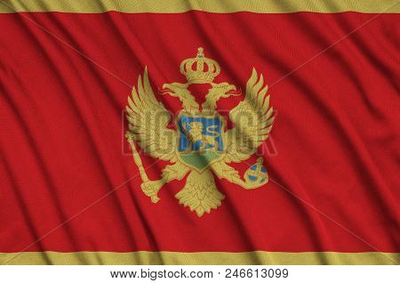 Montenegro Flag  Is Depicted On A Sports Cloth Fabric With Many Folds. Sport Team Waving Banner