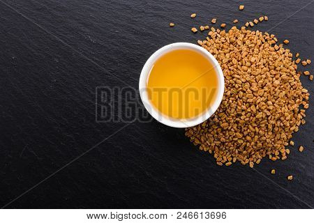 Fragrant Grains Of Fenugreek On A Rustic Background.