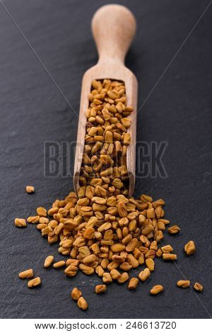 Fragrant Grains Of Fenugreek On A Rustic Background.