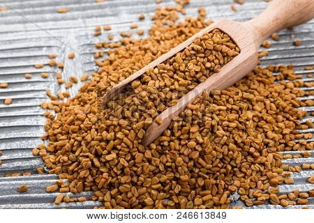 Fragrant Grains Of Fenugreek On A Rustic Background.