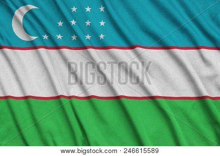 Uzbekistan Flag  Is Depicted On A Sports Cloth Fabric With Many Folds. Sport Team Waving Banner