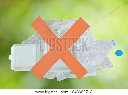 Red Cross In Front Of Plastic Bag Bottle And Foam On Blur Green Background