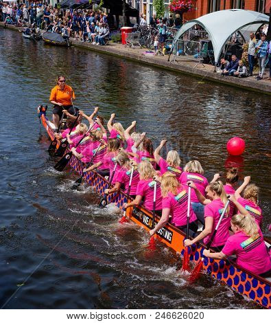 Leiden, Holland, June 23th, 2018: Traditional Red Dragon Boat Races In Leiden Canal, Rowing Teams Co