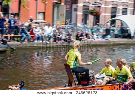 Leiden, Holland, June 23th, 2018: Traditional Red Dragon Boat Races In Leiden Canal, Rowing Teams Co