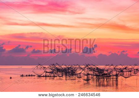 golden sky above fishing trap in Pak Pra Talay Noi sea Phatthalung south of Thailand