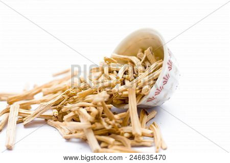 Close Up Of Ayurvedic Herb  Satavari Or Kurilo Or Asparagus Racemosus Isolated On White In A Glass B