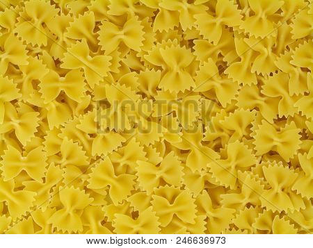 Uncooked Yellow Italian Pasta Farfalle Texture Close-up