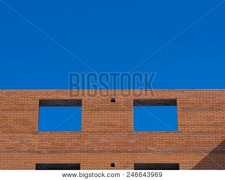 Closeup On Windows Hole Construction With Concrete Lintel. Unfinished House. Blue Sky Background