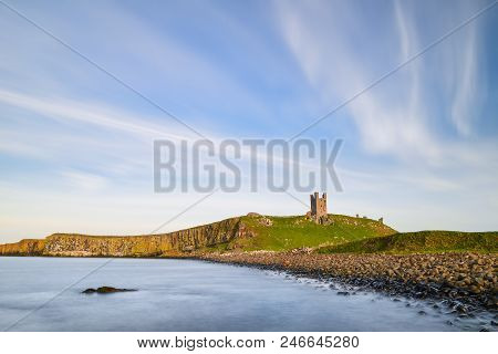 Beautiful Landscape Image Of Dunstanburgh Castle On Northumberland Coastline In England During Late 