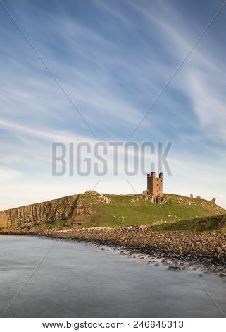 Beautiful Landscape Image Of Dunstanburgh Castle On Northumberland Coastline In England During Late 