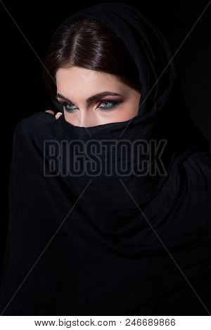 Beautiful Muslim Woman In Niqab Traditional Veil Against On Dark Background