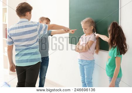 Children bullying their classmate in school