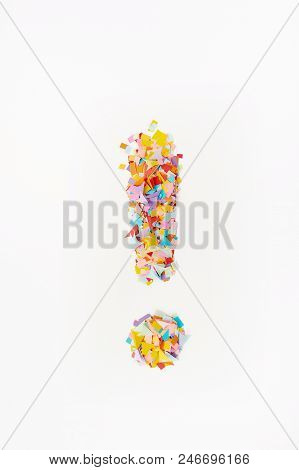 Multi-colored Confetti From Paper. The Exclamation Mark On A  Background From Multi-colored Confetti