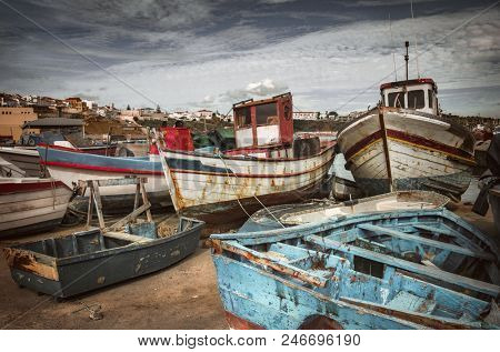 Old fishing boats docked in a port in Sines - Portugal