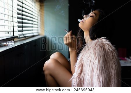 Charming Beautiful Sexy Woman Is Smoking Marijuana Or Cigarette. Attractive Beautiful Girl Feel Rela