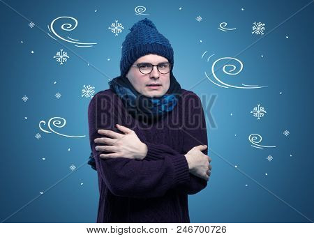 Young hipster frozen boy with doodled snowflakes and windy concept