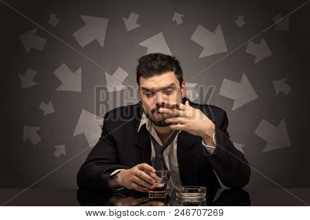Drunk disappointed man sitting at table with arrows around