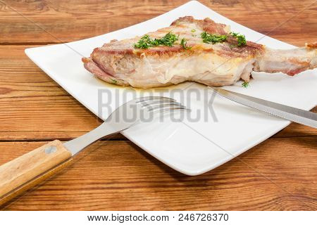 Fragment Of Dish With Grilled Pork Loin Chop With Partly Frenched Rib And Sprinkled With Chopped Dil