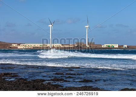 Modern Windmills On The Beach. Landscape With Nature And Technology