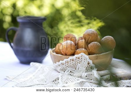 Small Balls Of Freshly Baked Homemade Cottage Cheese Doughnuts In A Plate . Donuts In Powdered Sugar
