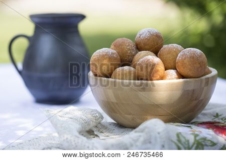 Small Balls Of Freshly Baked Homemade Cottage Cheese Doughnuts In A Plate . Donuts In Powdered Sugar